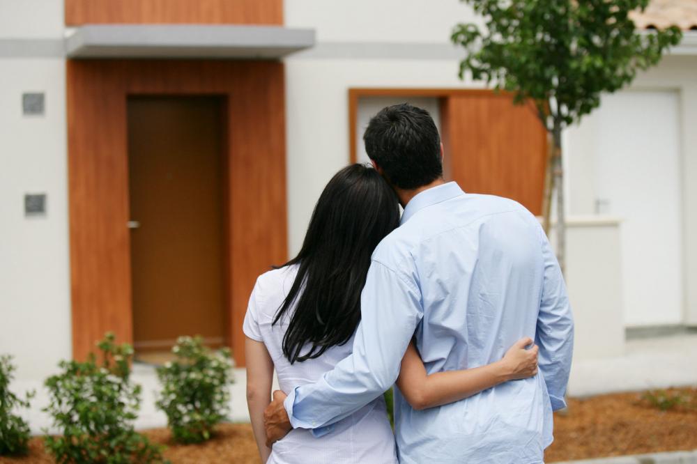 a couple looking at their new home after taking out a mortgage loan.